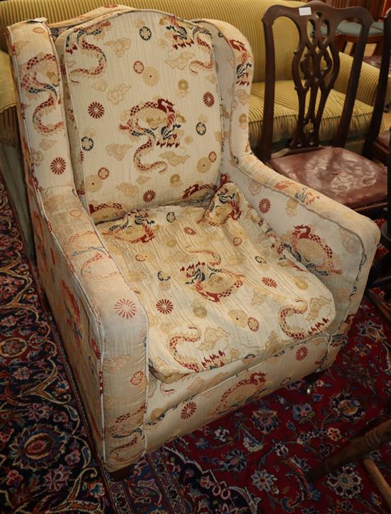 A late Victorian upholstered wing armchair